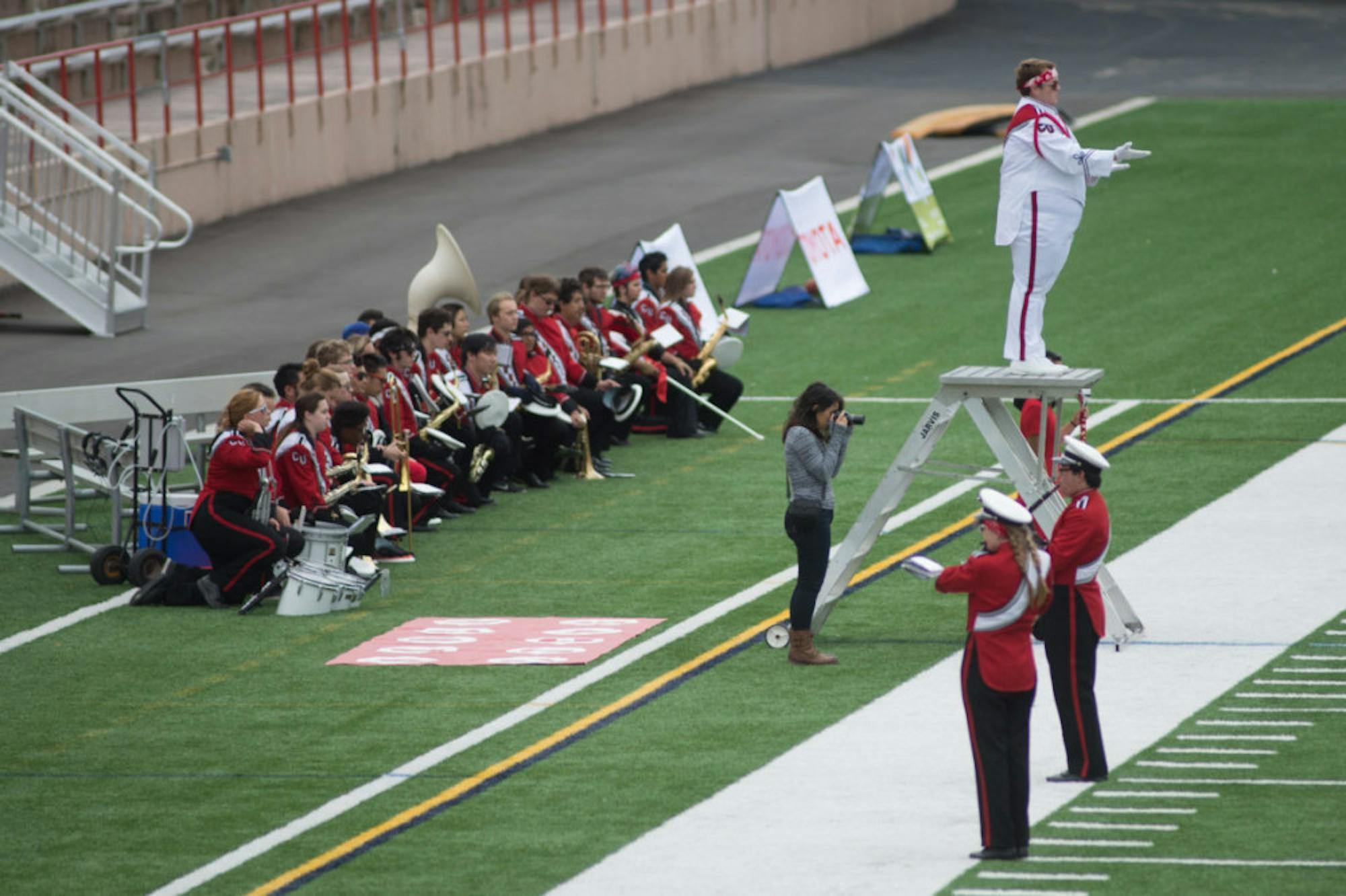 Members of the Big Red Marching Band take a knee during the national anthem before football's game against Colgate Saturday.