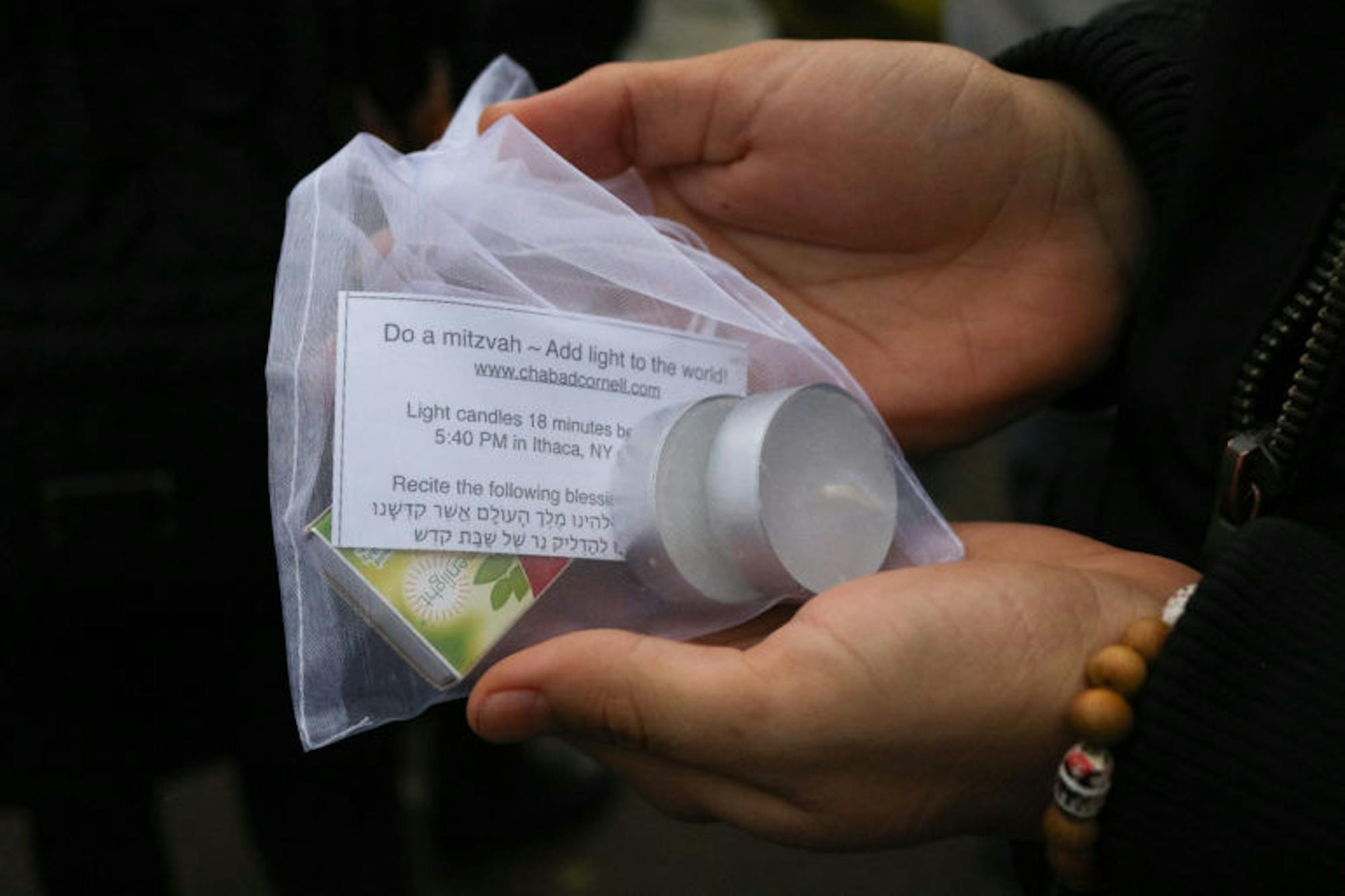 Organizers of the vigil handed out candles, encouraging Cornellians to rally against hate and darkness. (Avonlea Matheny / Sun Staff Photographer)
