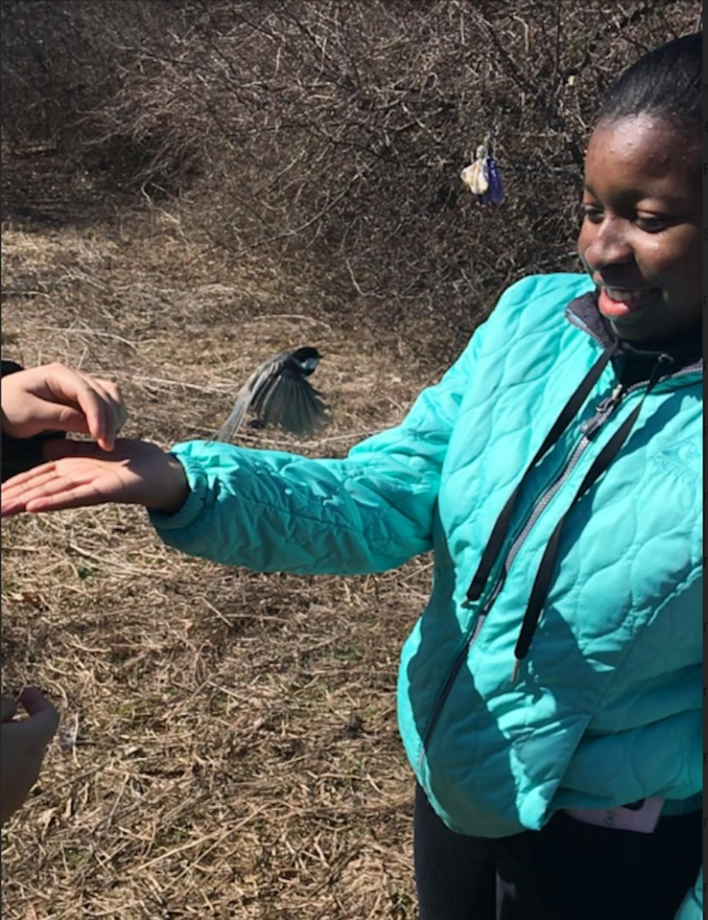 <p>Junior Nataysha Owens releases a bird.&nbsp;</p>