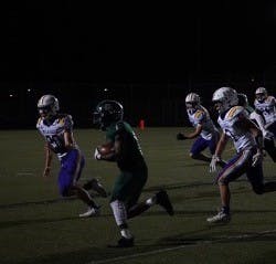 Senior running back Brent Parker moves past the defense. Photo by Quinten Love.