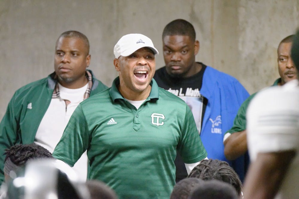 <p>Cass Tech coach Thomas Wilcher addresses his team at Ford Field.</p>