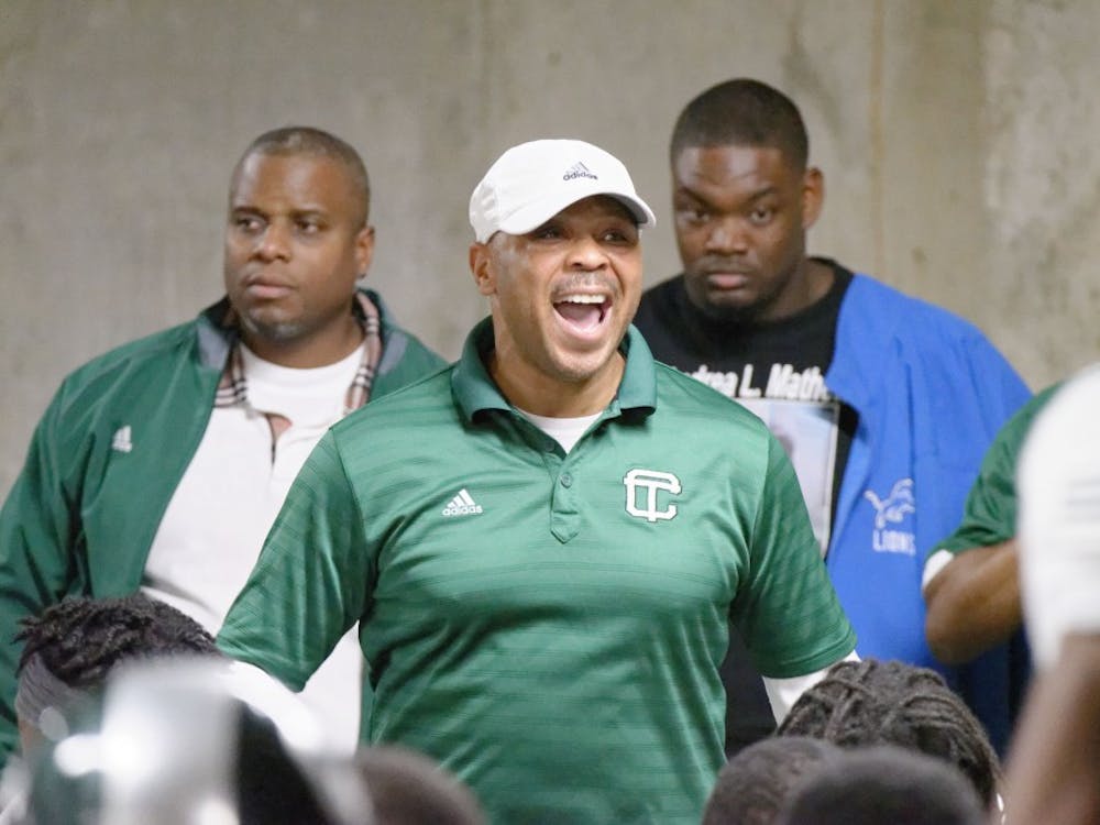 Cass Tech coach Thomas Wilcher addresses his team at Ford Field.