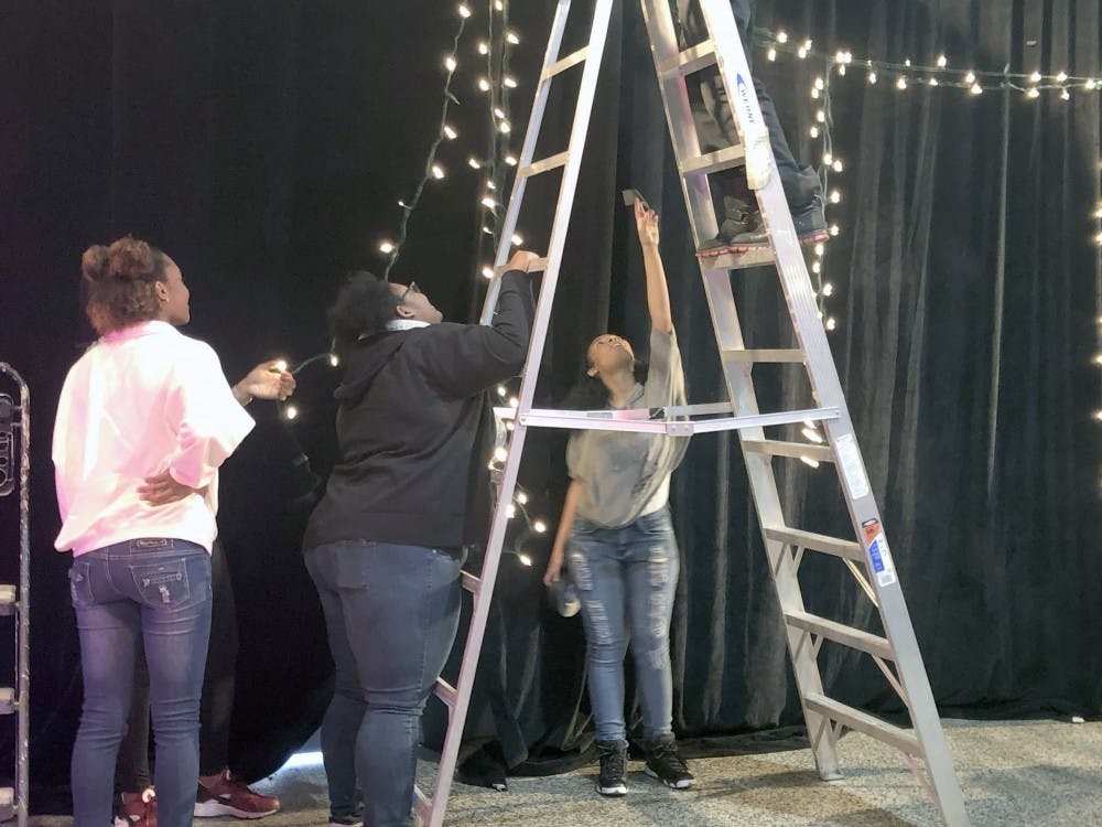 Three Detroit School of Arts students work as stage managers at a behind-the-scenes event for Kamal Smith. Being a stage manager is a job typically stereotypically meant for men.