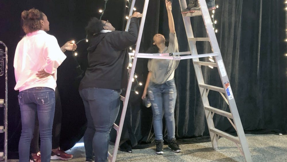 Three Detroit School of Arts students work as stage managers at a behind-the-scenes event for Kamal Smith. Being a stage manager is a job typically stereotypically meant for men.