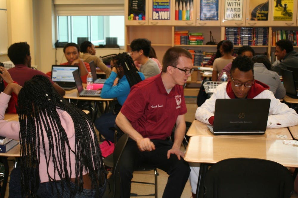 <p>Mr. Sweet assists a student working on his own app.</p>