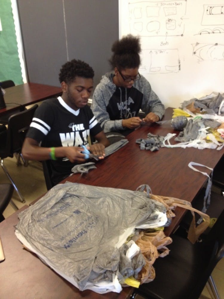 Seniors Shaylan Harden and&nbsp;Taja Evans work meticulously to create their blanket.&nbsp;