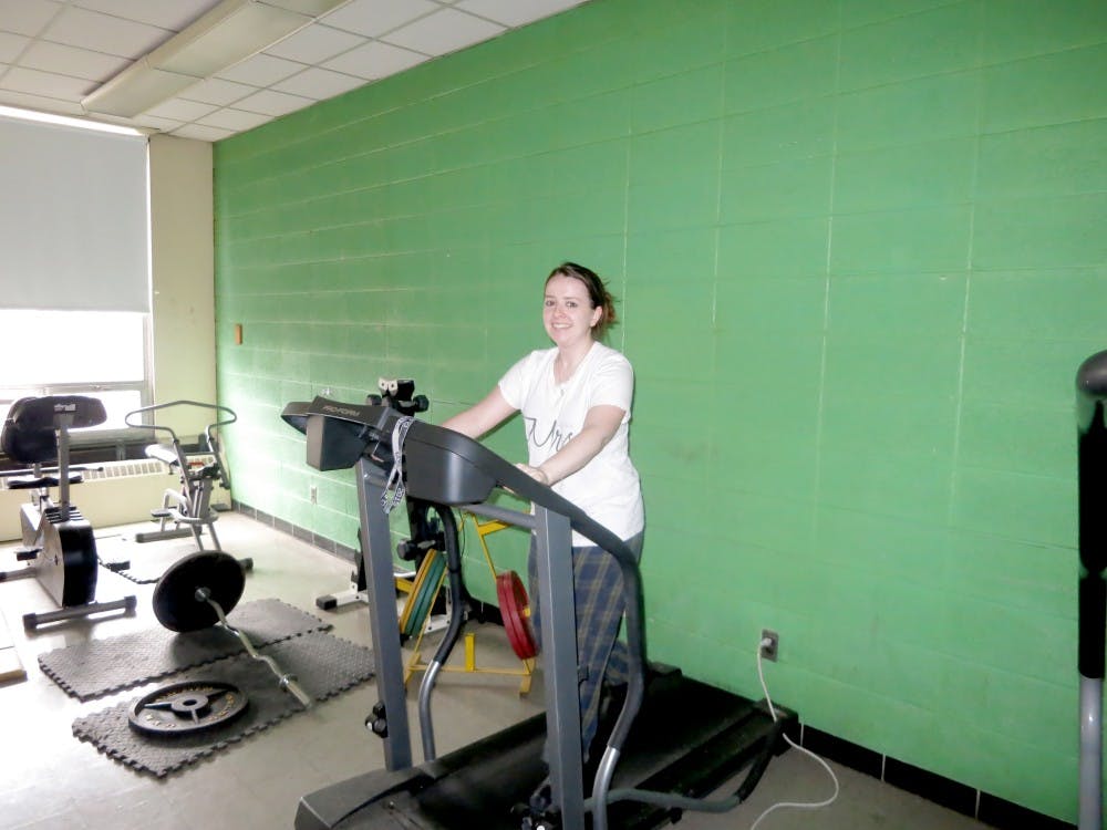 <p>Douglass resource teacher Amanda Morris works out a treadmill during her prep time.</p>