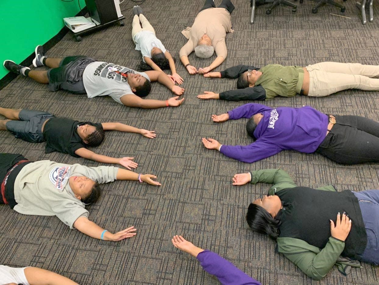 Students and faculty participate in meditation exercises in a new class at Southeastern High School.