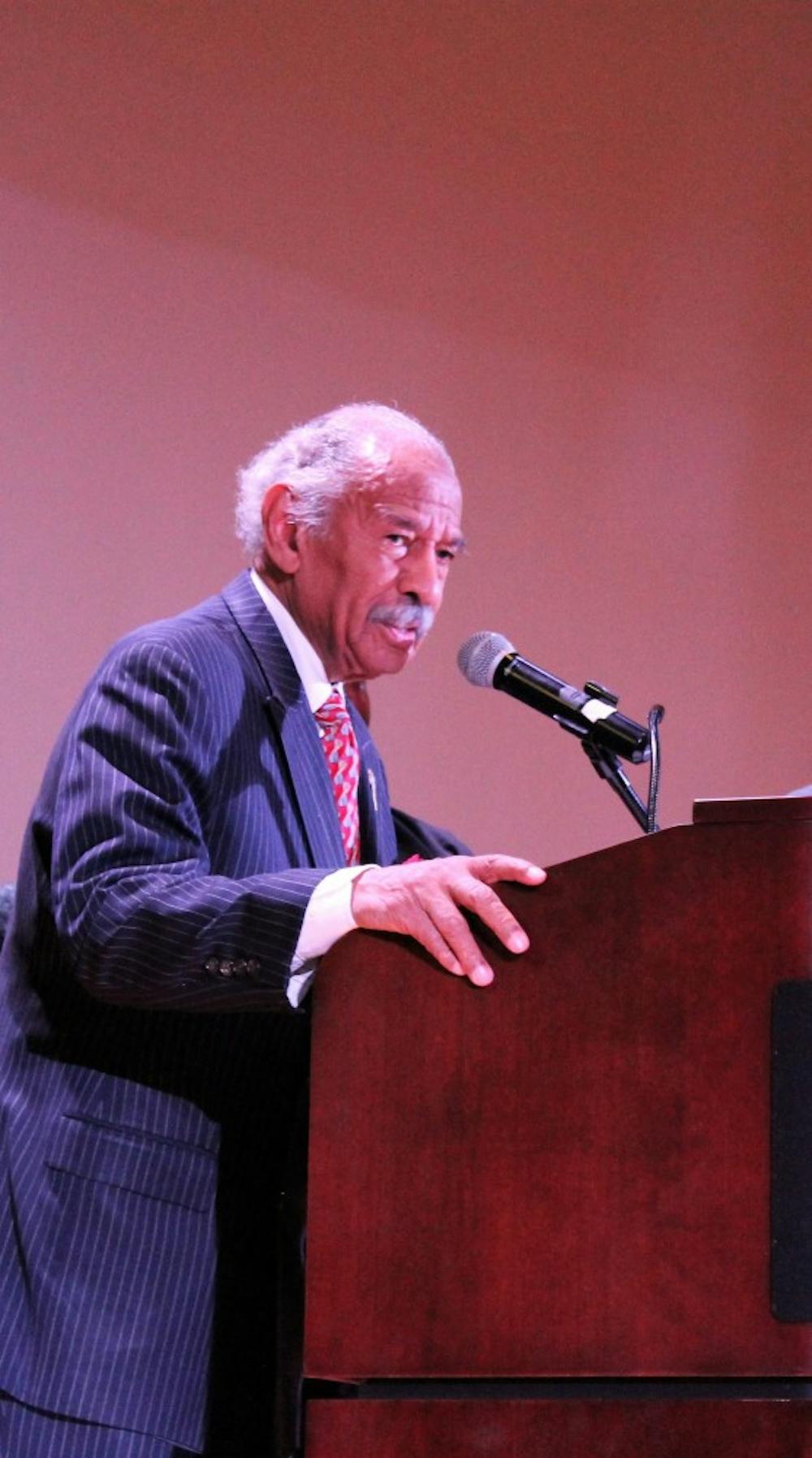 <p>Congressman John Conyers addresses a packed auditorium with words of encouragement about unity for all people.</p>