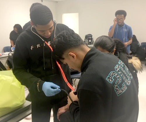 Jamari Childs takes Suliman Islam’s vitals as Aniqa Usha assists. Photo by Sarah Kabala.