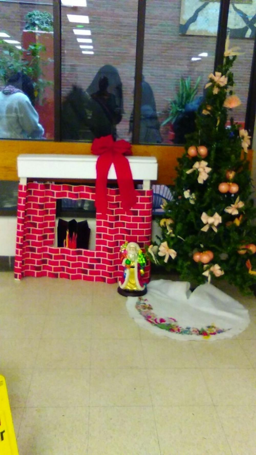 <p>Detroit International Academy is filled with ladies who celebrate a variety of holidays in December, including Christmas. A fake fireplace and tree are set up in the lunchroom at DIA.</p>