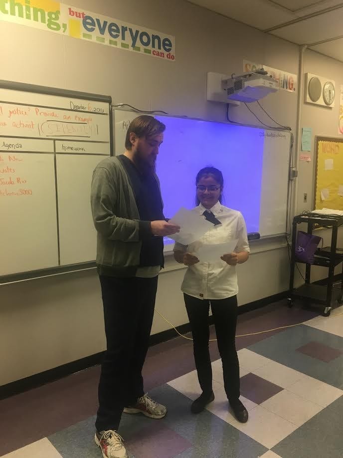 Social Studies&nbsp;Teacher Cody Lown works with a student at Benjamin Carson High School