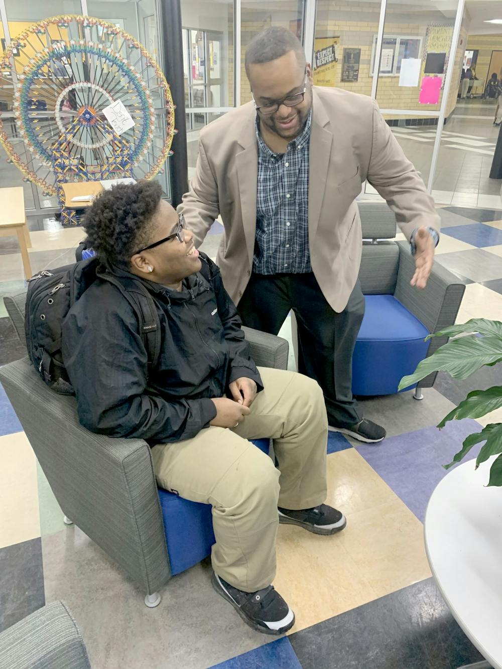 <p>James Mallett offers some advice to Anthony Hall as part of the school’s Brotherhood organization. Photo by Eric Major.</p>