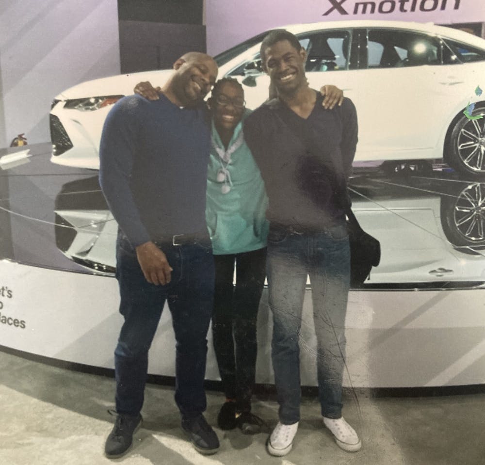 <p>Arshana Brown, center, with her dad and sibling, Adrienne, at the 2018 Detroit Auto Show.</p>