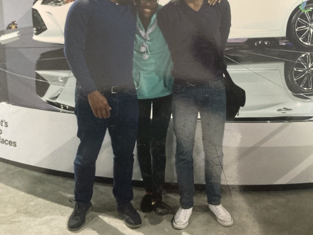 Arshana Brown, center, with her dad and sibling, Adrienne, at the 2018 Detroit Auto Show.