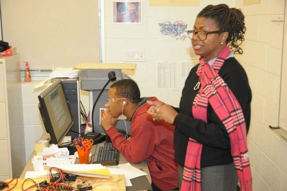 Mrs. Minor prepares for a robotic competition with students at East English Village.