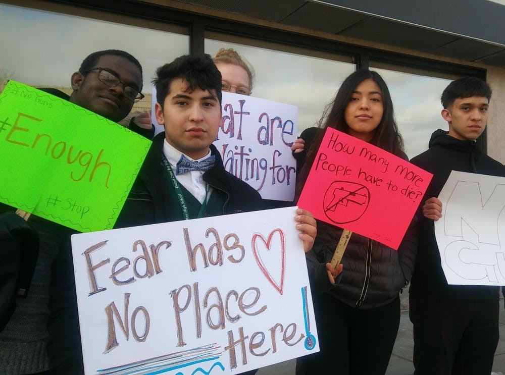 Detroit Cristo Rey students stand on Vernor Ave. to raise awareness of gun violence during the #enough National School Walkout.