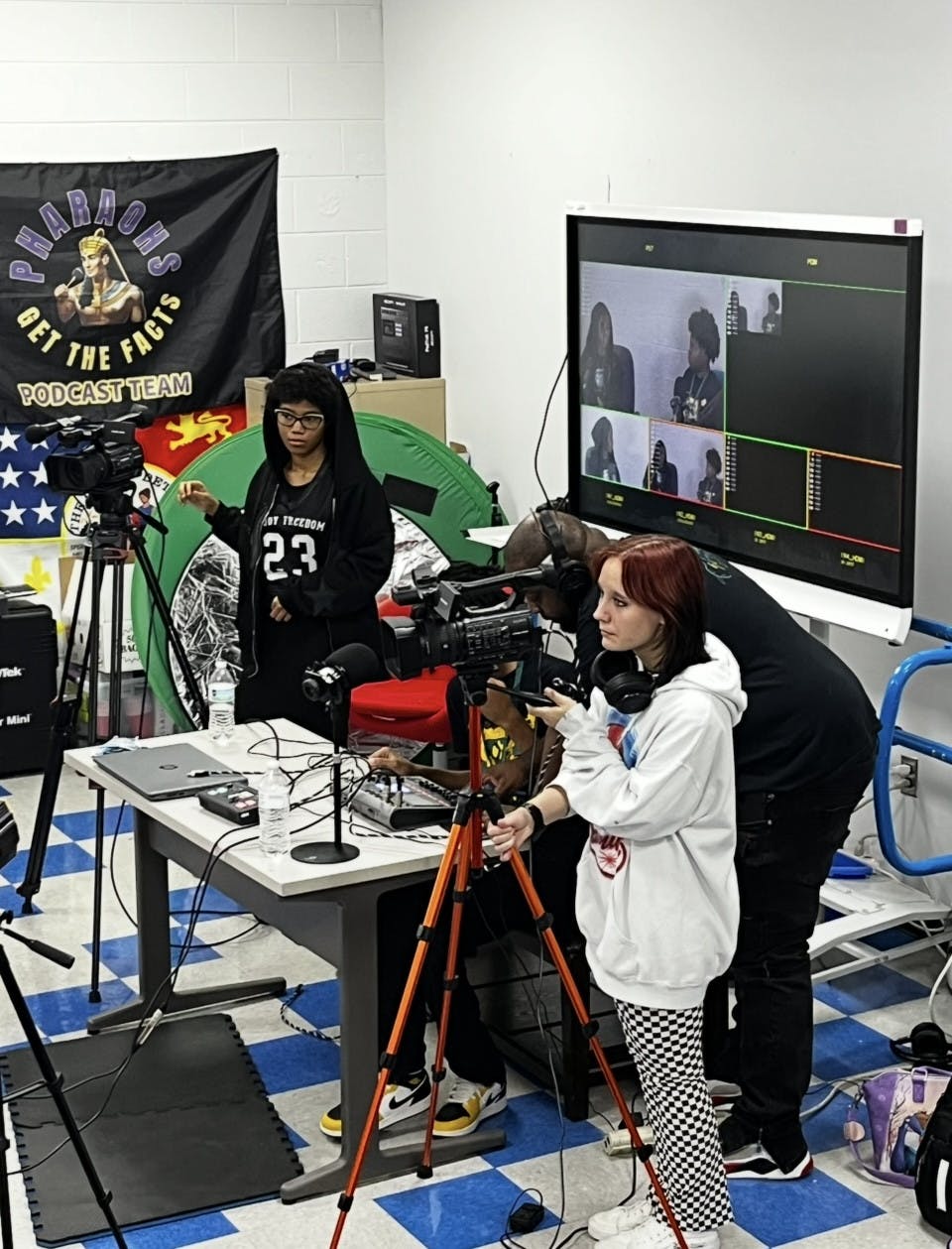 Students Ashton Reece, Chet Pitts, and Ethan Rembert assist in filming the production of a student ran podcast. Photo by The Communicator.