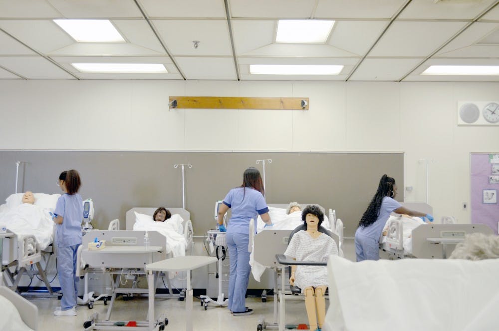 Seniors Blanch Suddeth, Janiya Coleman and Tayia Mitchell practice patient care. “I enjoy the program a lot,” senior Tylesha Clark said.