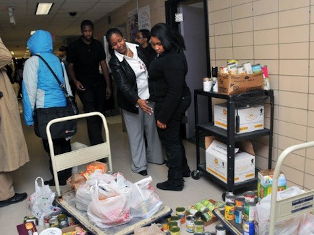 CMA vice principal Cox and students gather canned goods for the less fortunate.