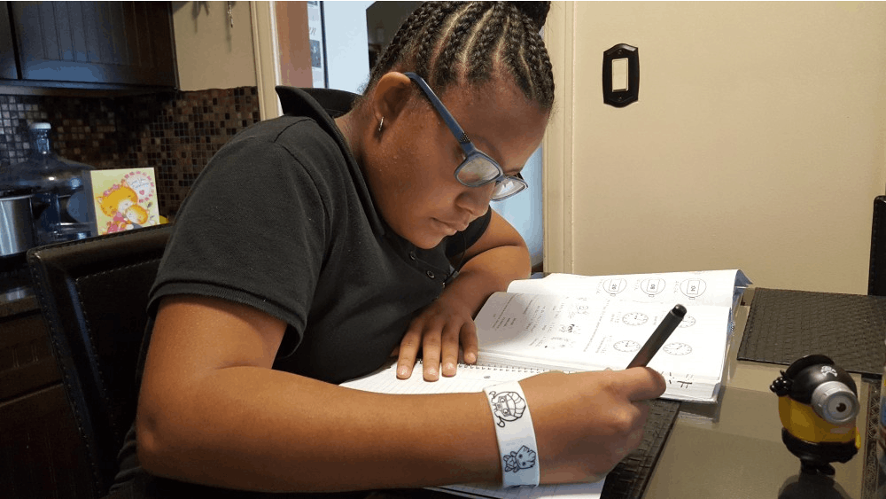 Foreign Language Immersion student Anaya Smith completes her Japanese homework at the kitchen table.