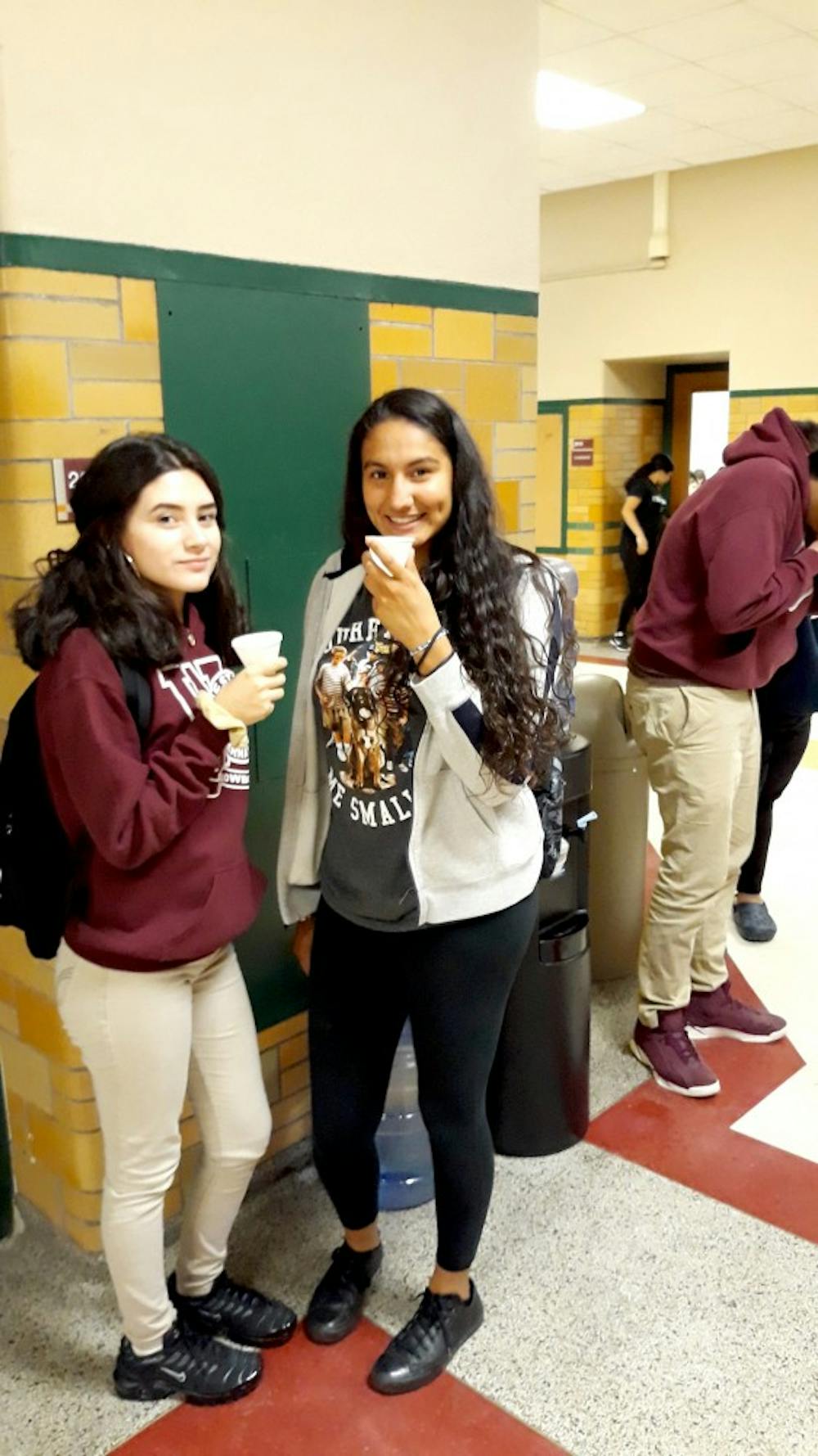 <p>Sophomores Ceslia Galindez and Frida Diaz stop to grab a drink at one of the many water coolers available in the halls of Western.</p>