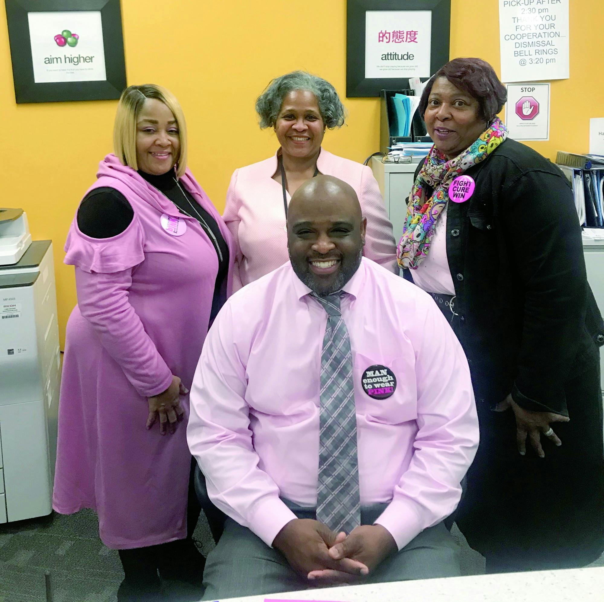 East English Village principle Dr. Larry Gray, seated, and his administrative staff participated in Pink Out Day on Oct. 14.