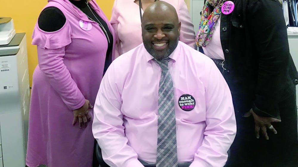 East English Village principle Dr. Larry Gray, seated, and his administrative staff participated in Pink Out Day on Oct. 14.