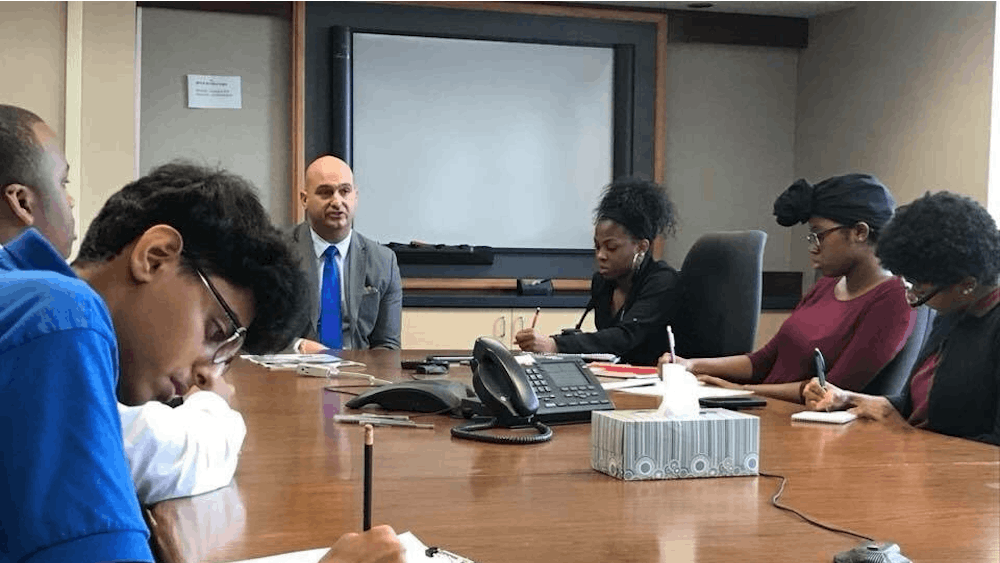 Osama Aldahan, reporter for the Benjamin Carson Diagnostic, and other Dialogue reporters take notes while interviewing Superintendent Vitti.&nbsp;