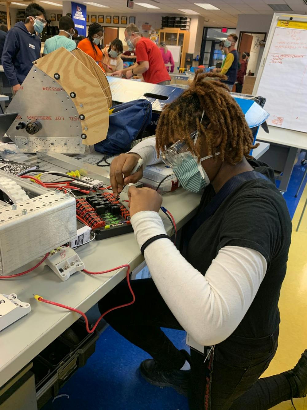 <p>Sophomore Chiann Hamilton wires the electrical for a competition robot at the Michigan Engineering Zone. Photo by Crusaders' Chronicle.</p>