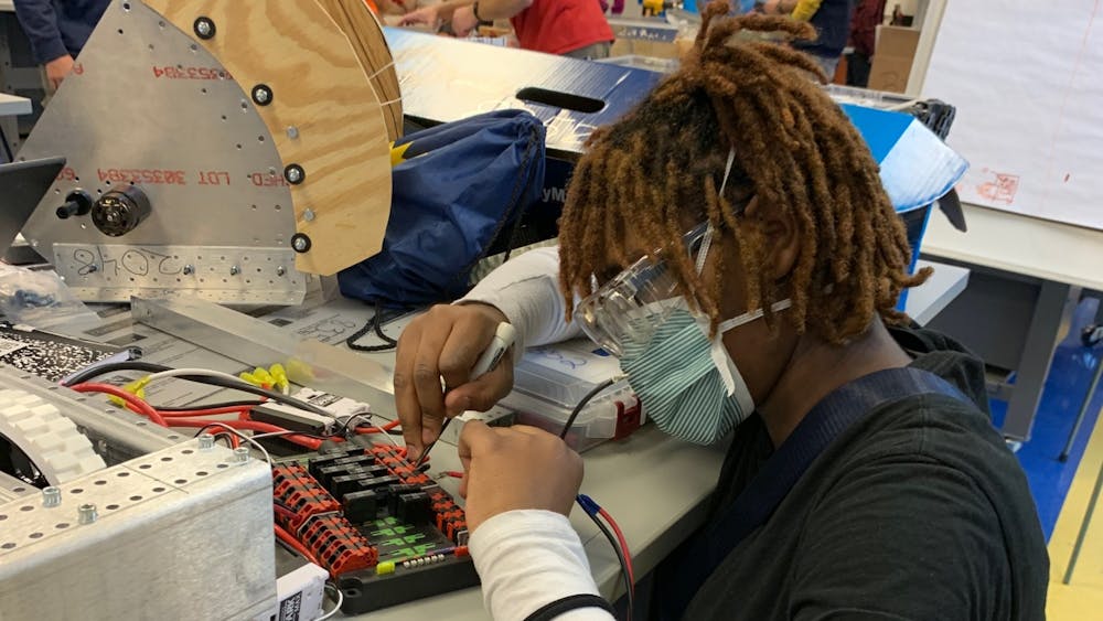 Sophomore Chiann Hamilton wires the electrical for a competition robot at the Michigan Engineering Zone. Photo by Crusaders' Chronicle.