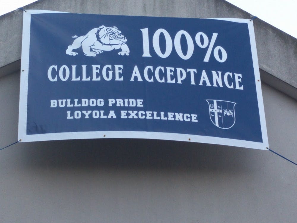 <p>Loyola High School proudly displays a banner announcing 100% college acceptance for its seniors.</p>