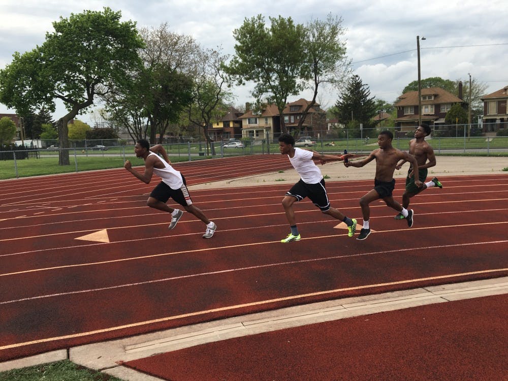 From left to right: Christian Jones, Phillip Wade, Evan Rogers and Branden Davis practice the blind exchange at track practice.