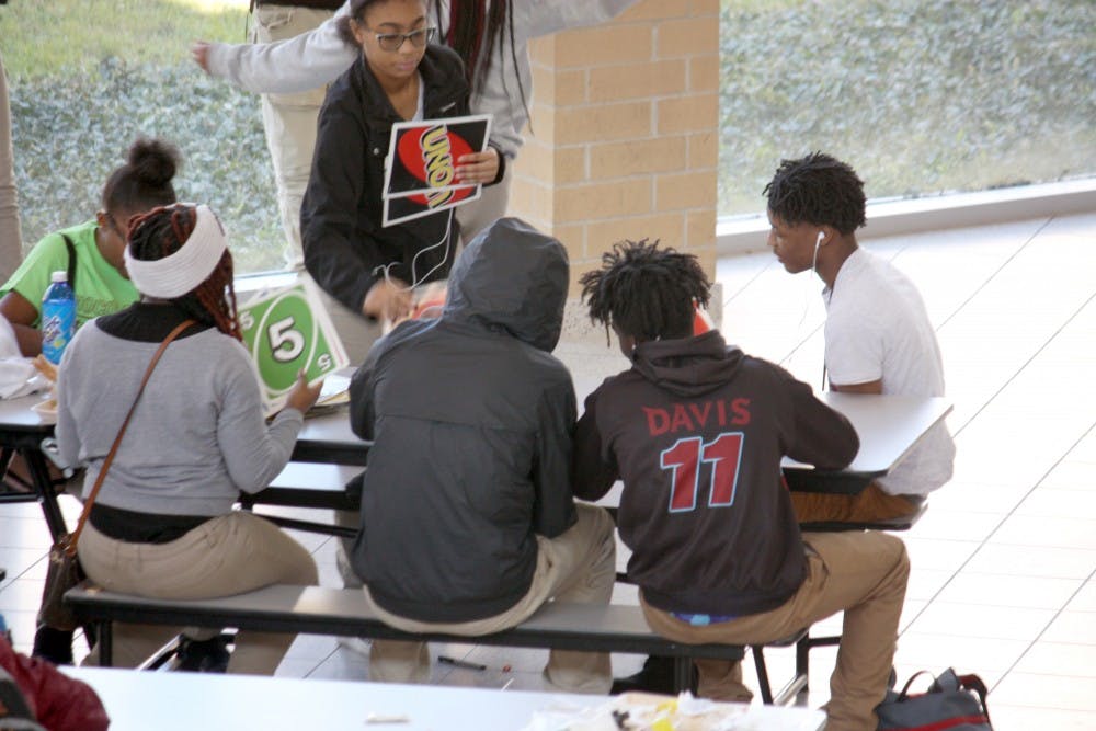 Students play giant Uno while they eat lunch in the Mumford cafeteria on Oct. 25. Giant Jenga and giant Connect 4 are also popular.&nbsp;