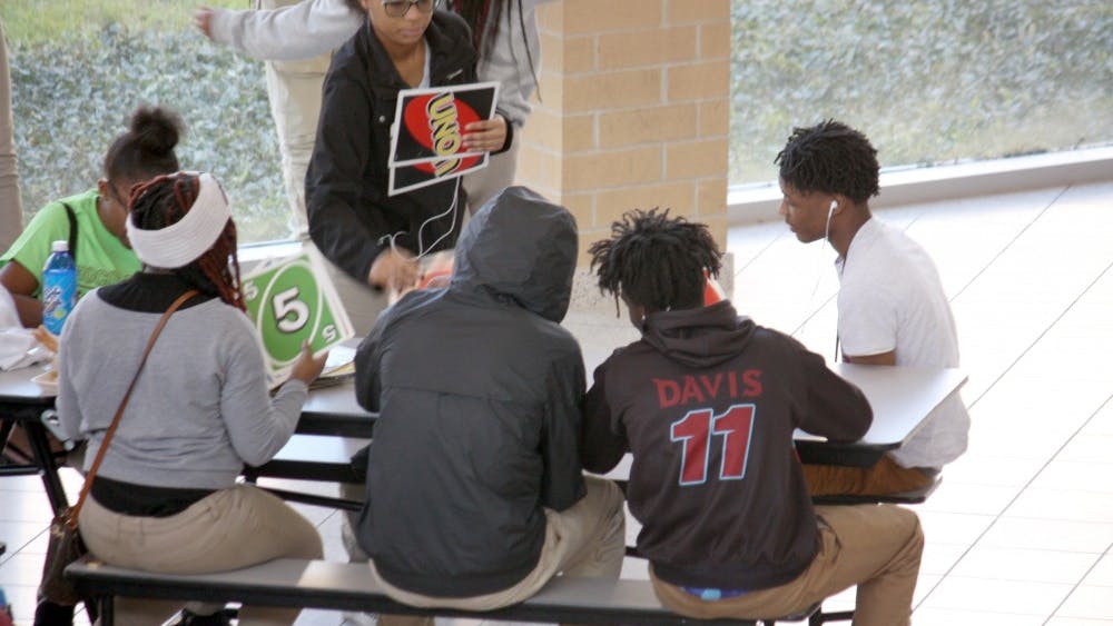 Students play giant Uno while they eat lunch in the Mumford cafeteria on Oct. 25. Giant Jenga and giant Connect 4 are also popular.&nbsp;