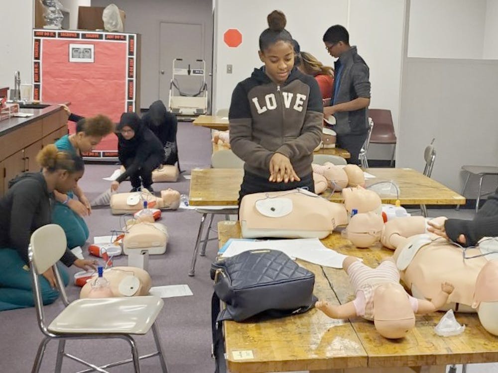 Shyla Hudson and Symphony Isabelle practice CPR on mannequins along with other students. Photo courtesy of Gwendolyn Mia.