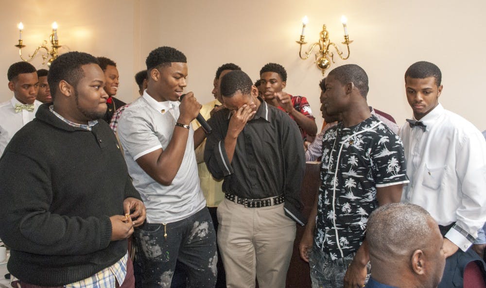 <p>Douglass senior Chase Davis is surprised and tearful as Douglass senior class vice president Kamar Graves calls all the seniors to the front to pin Davis.</p>