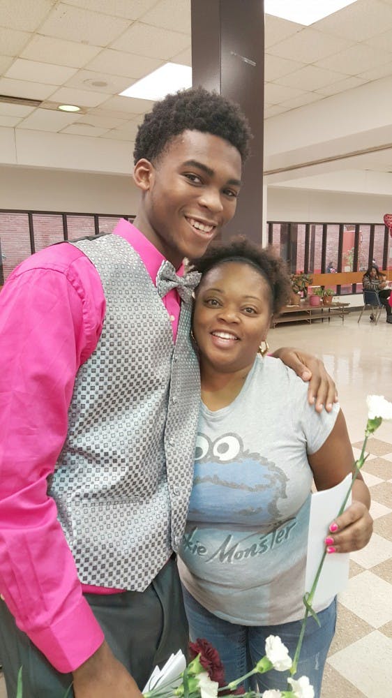 A member of Douglass' Dream Kings delivers a flower to one of the ladies of Detroit International Academy.