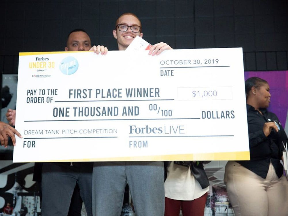 Davon Schelgel holds the first place check from the “Shark Tank”-style competition. Competitors had to pitch their business ideas to win a $1,000 starting check provided by Forbes. Courtesy photo.