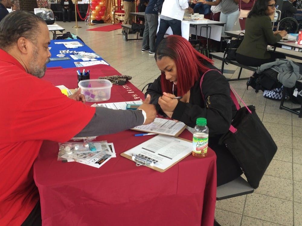 Darwin Griffin from Metro Detroit&nbsp;AFL-CIO&nbsp;helps junior Tiyatta Young fill out a voter registration form during Mumford's 2nd Annual Career Day Expo on Feb. 16.&nbsp;
