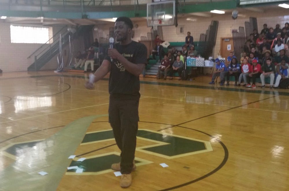 <p>Slam poet Abdoulaye Doumbouya performs at the College Decision Day in the Cody gym on May 14. The DIT senior will go to the US Army on July 18.</p>