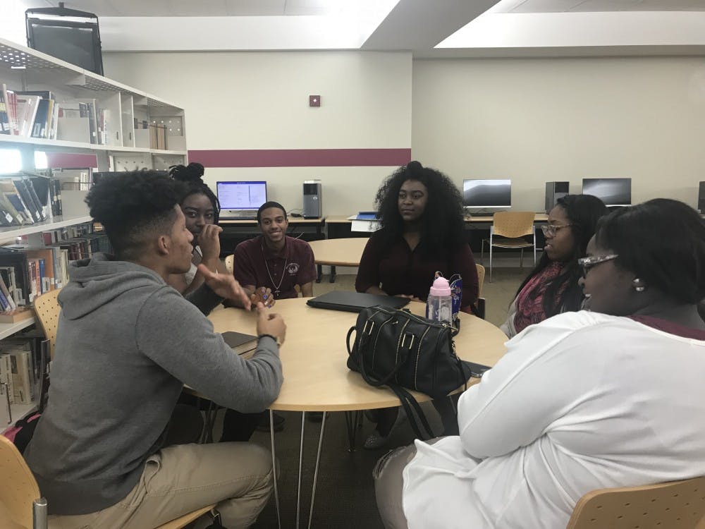 S.A.L.T members gather around table to discuss topics regarding race, politics and religion.