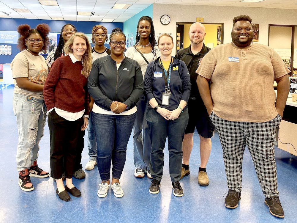 Seniors Lauren Robinson, Diamond Sewell Chiann Hamilton, and robotics teacher Carrie Russell spent time with Ford’s staff at the MEZ. PHOTO BY CRUSADERS' CHRONICLE