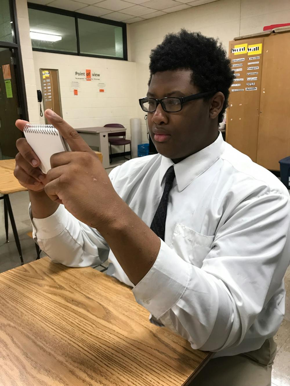 <p>Douglass student Matthew Patterson uses notecards to aid his studying. </p>
