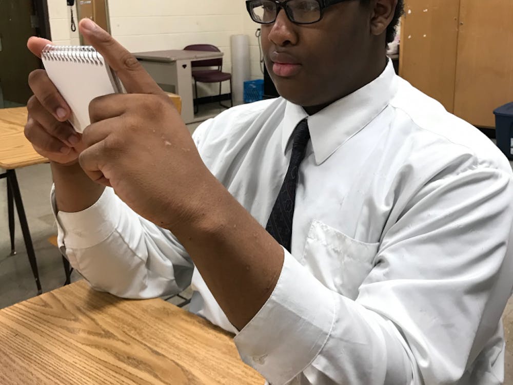 Douglass student Matthew Patterson uses notecards to aid his studying. 