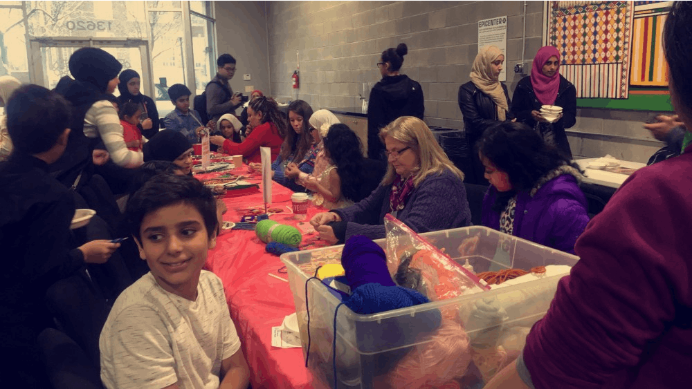 Cristo Rey staff and students help children make crafts&nbsp;at the National Arab American Museum's Christmas party.