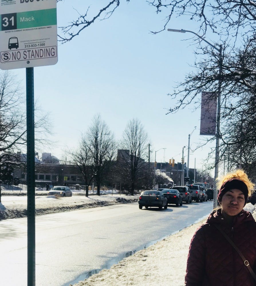 BCHS senior Olivia Ervin waits by a bus stop on a snowy day.