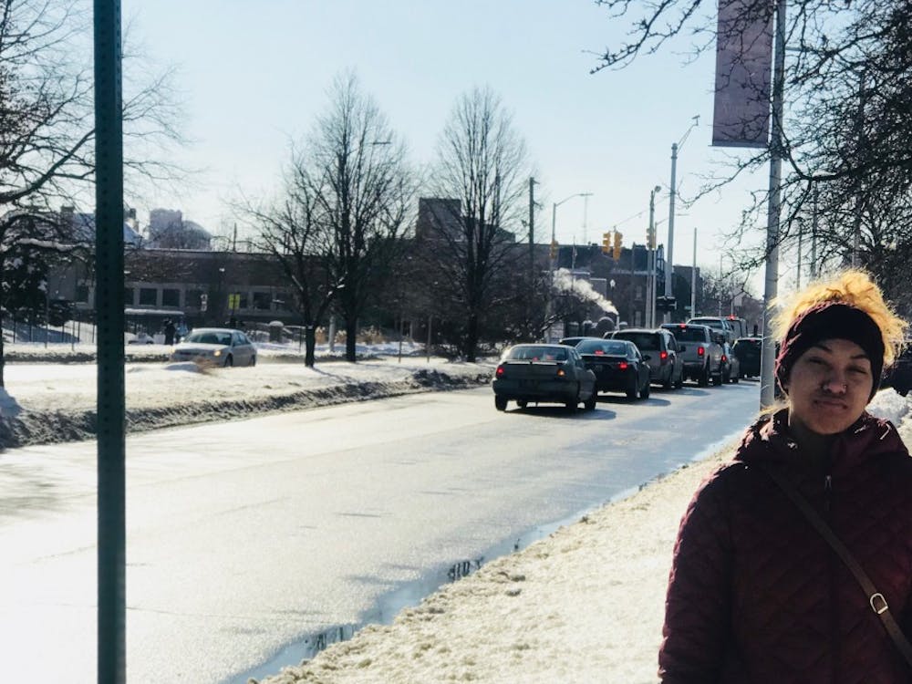 BCHS senior Olivia Ervin waits by a bus stop on a snowy day.