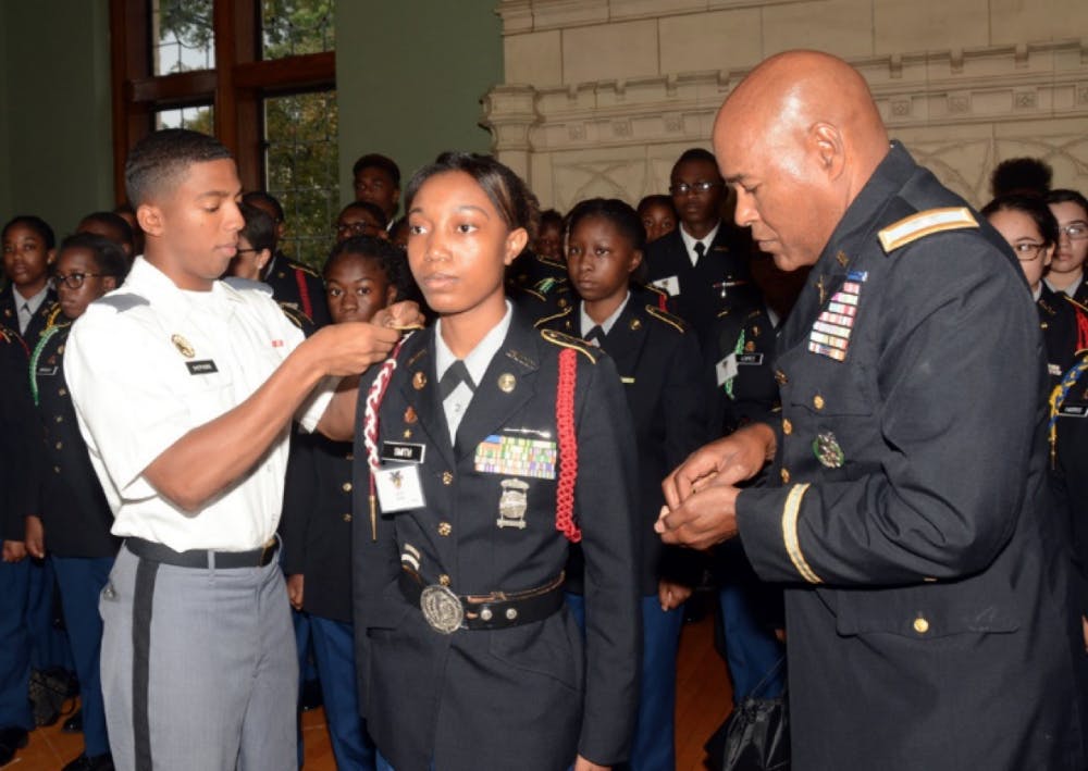 Core Commander Lawerence Shepherd (right) honors Lauryen Smith alongside Colonel George Pettigrew (left), Director of Army Instruction in Detroit Public Schools