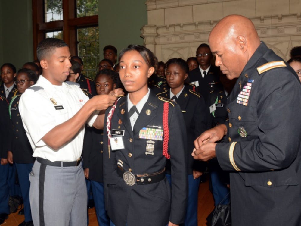 Core Commander Lawerence Shepherd (right) honors Lauryen Smith alongside Colonel George Pettigrew (left), Director of Army Instruction in Detroit Public Schools